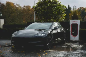 Tesla Model 3 parked at a Supercharger charging station.