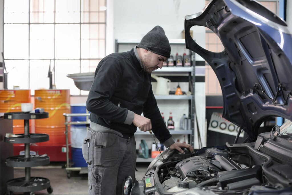 Mechanic inspecting a car engine in a garage